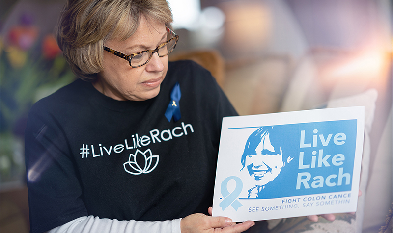 Pat Monson holing a "Live Like Rach" publication