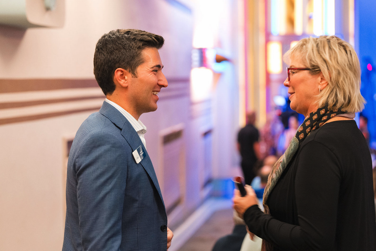 Impact Foundation Board Member Jacob Strinden speaks to event guest