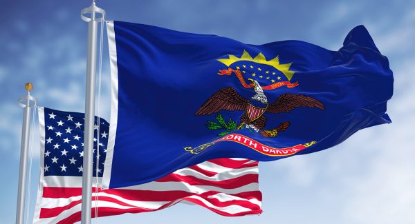 The North Dakota state flag waving along with the national flag The North Dakota state flag waving along with the national flag of the United States of America.